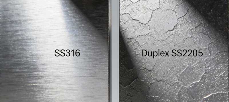 A close-up macro photograph highlighting the difference in surface finish and structure between standard SS316 and the textured grain of Duplex SS2205.